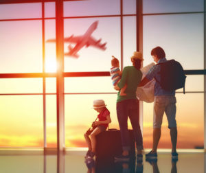 54723386 - happy family with suitcases in the airport.